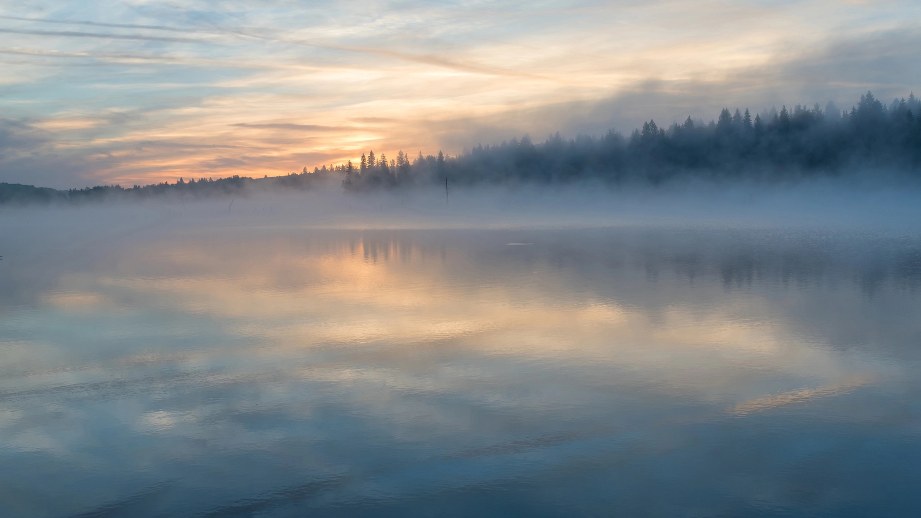 Nordic lake sunrise in mist